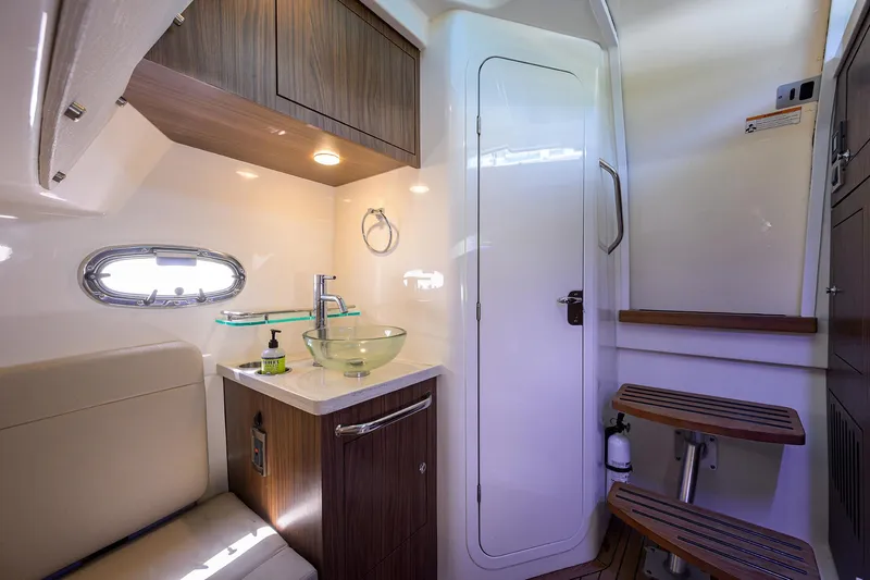 Who's Sippin Yacht Photos Pics Interior of 2021 Boston Whaler 380 Outrage, featuring modern bathroom and seating area.