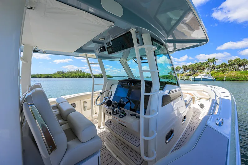 Who's Sippin Yacht Photos Pics 2021 Boston Whaler 380 Outrage boat interior with helm, seats, and water view.