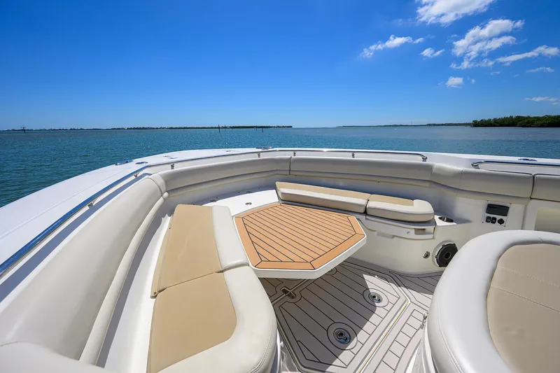 Who's Sippin Yacht Photos Pics Boston Whaler 380 Outrage 2021 boat interior with seating and table on a sunny day.