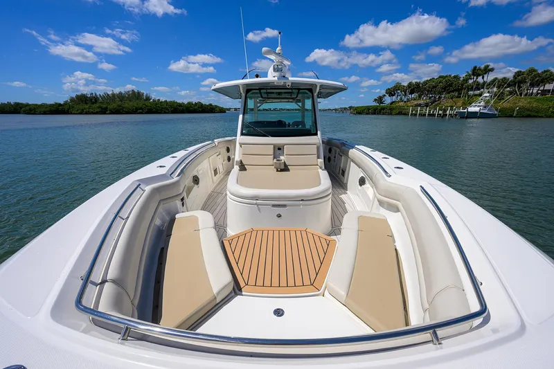 Who's Sippin Yacht Photos Pics 2021 Boston Whaler 380 Outrage boat on calm water, featuring spacious seating and clear skies.
