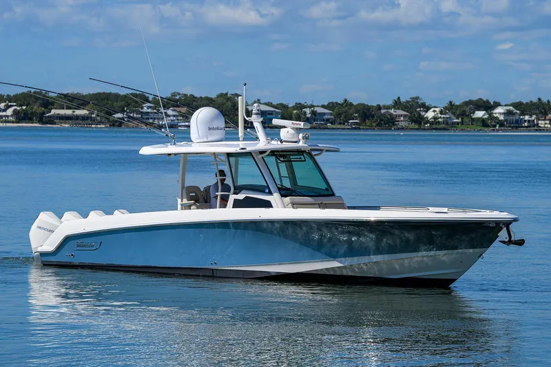 Who's Sippin Yacht Photos Pics 2021 Boston Whaler 380 Outrage boat on calm water, showcasing sleek design and modern features.
