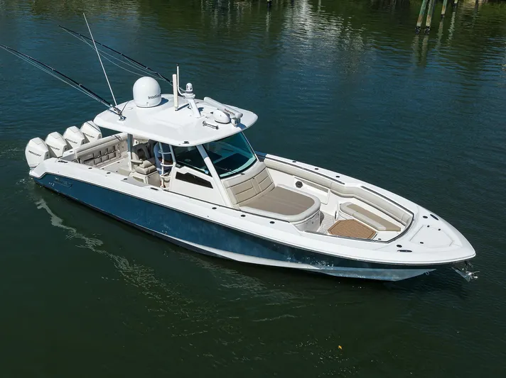 Who's Sippin Yacht Photos Pics 2021 Boston Whaler 380 Outrage boat on calm water, featuring sleek design and multiple engines.