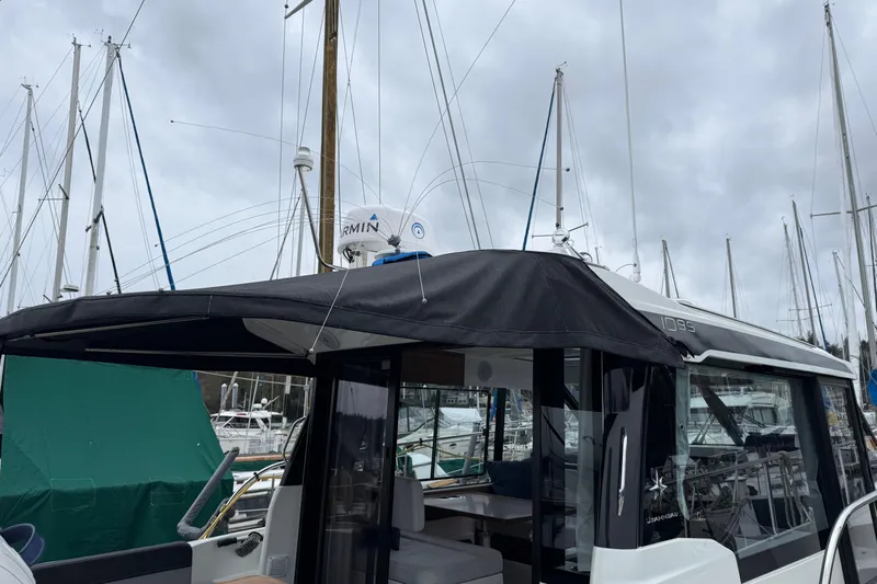  Yacht Photos Pics 2023 Jeanneau NC 1095 boat docked at marina with overcast sky.