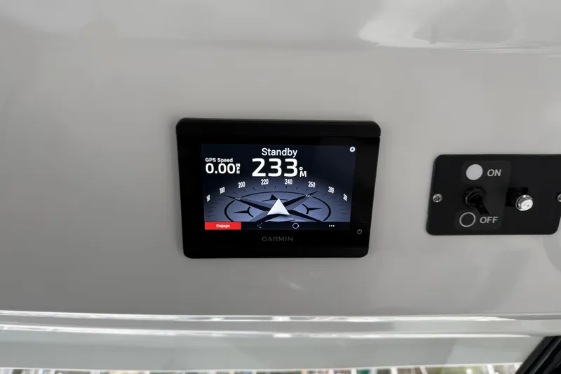  Yacht Photos Pics Garmin navigation display on 2023 Jeanneau NC 1095 boat dashboard, showing compass and controls.