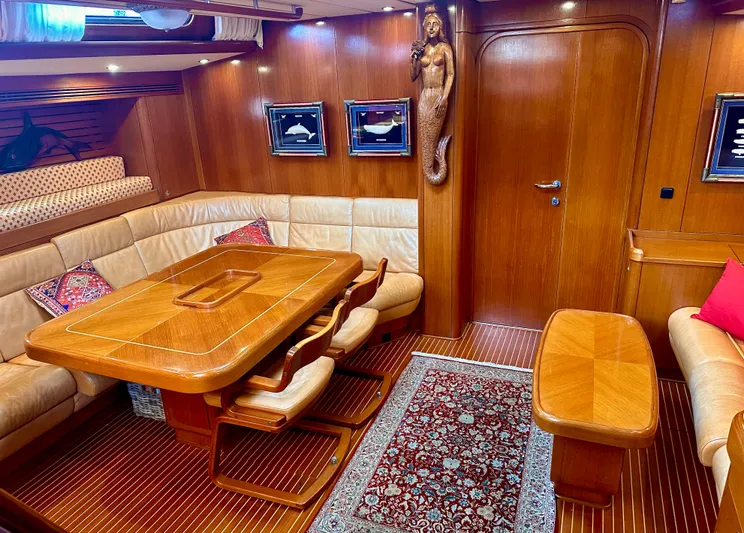 Taipan Tng Yacht Photos Pics Luxurious 2001 Nautor Swan 68 yacht interior with elegant wood finish and plush seating.