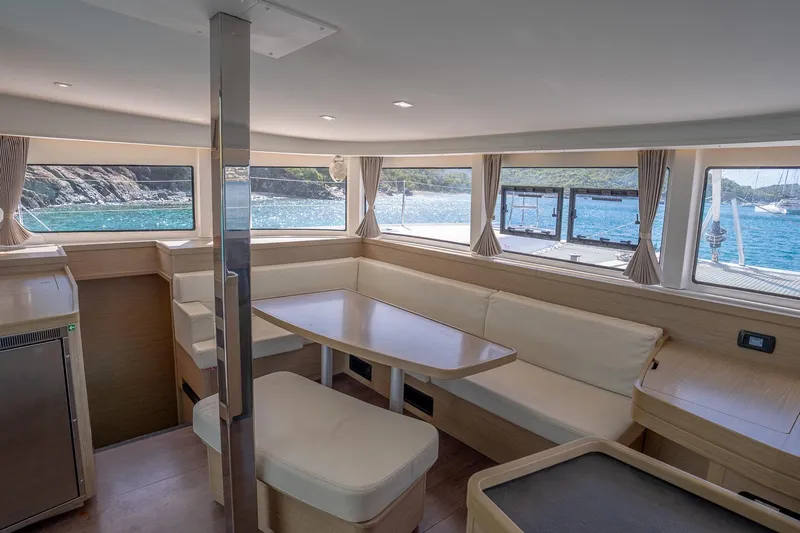 Tide Together Yacht Photos Pics Interior of 2023 Lagoon 42 catamaran with spacious seating and ocean view.
