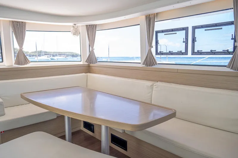 Tide Together Yacht Photos Pics Interior of 2023 Lagoon 42 catamaran with spacious seating and panoramic windows.