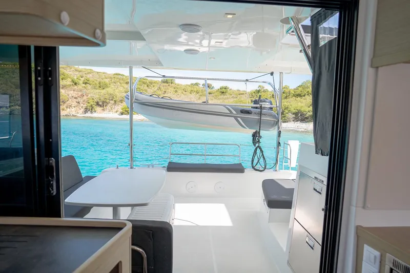 Tide Together Yacht Photos Pics Interior view of 2023 Lagoon 42 catamaran with scenic ocean backdrop.