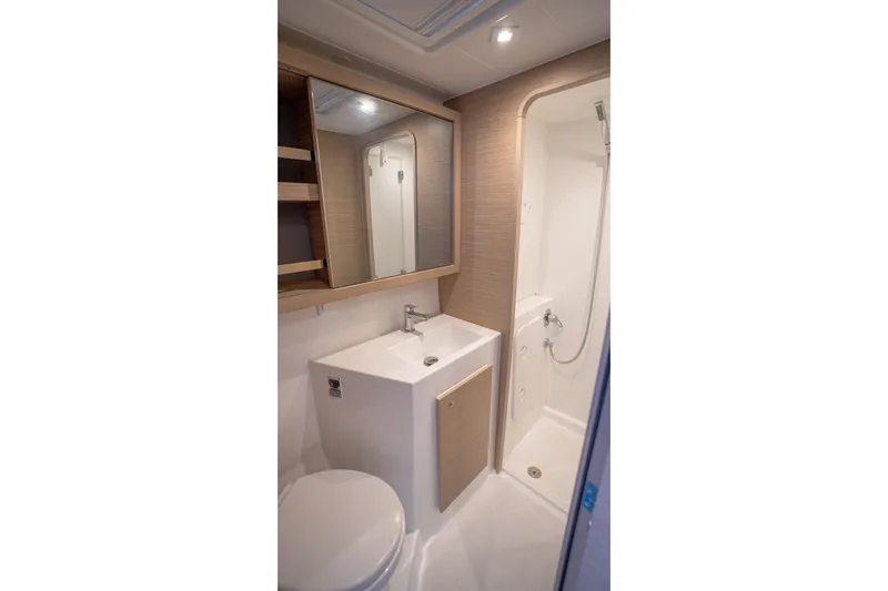Tide Together Yacht Photos Pics Modern bathroom in 2023 Lagoon 42 yacht with shower, sink, and mirror.