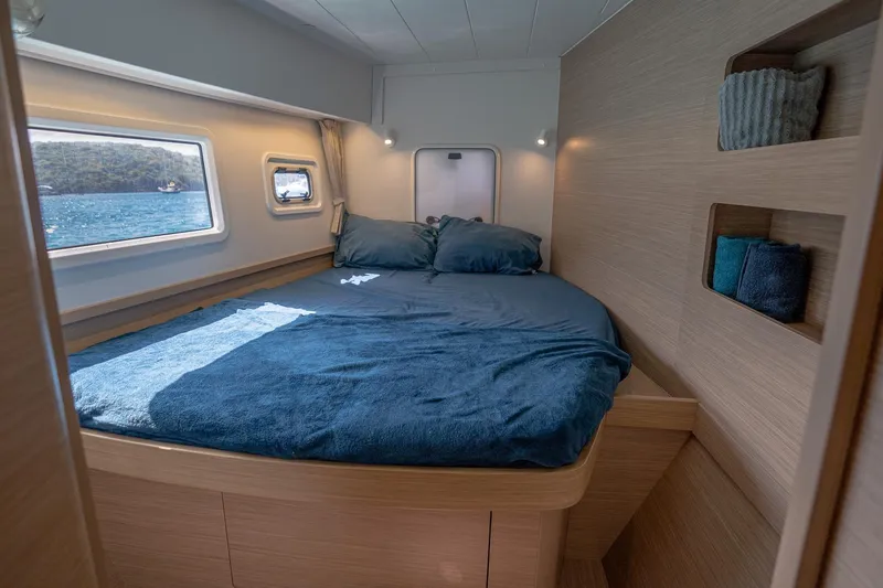 Tide Together Yacht Photos Pics Cozy cabin interior of 2023 Lagoon 42 catamaran with ocean view.