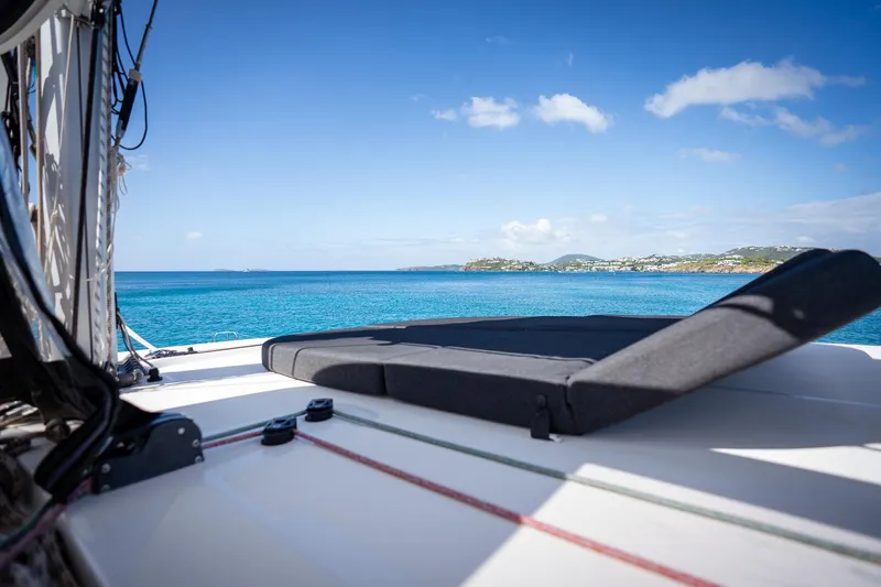 Tide Together Yacht Photos Pics 2023 Lagoon 42 catamaran deck with ocean view and distant coastline.