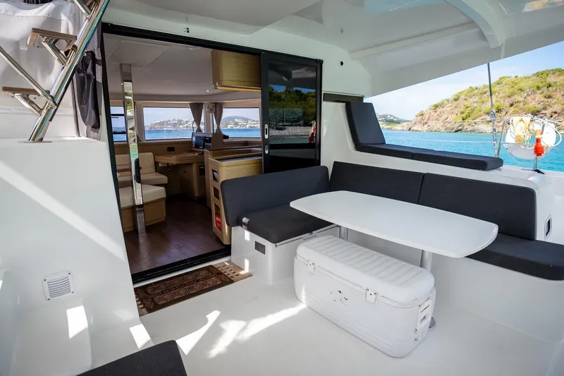 Tide Together Yacht Photos Pics 2023 Lagoon 42 yacht interior with seating area and ocean view.