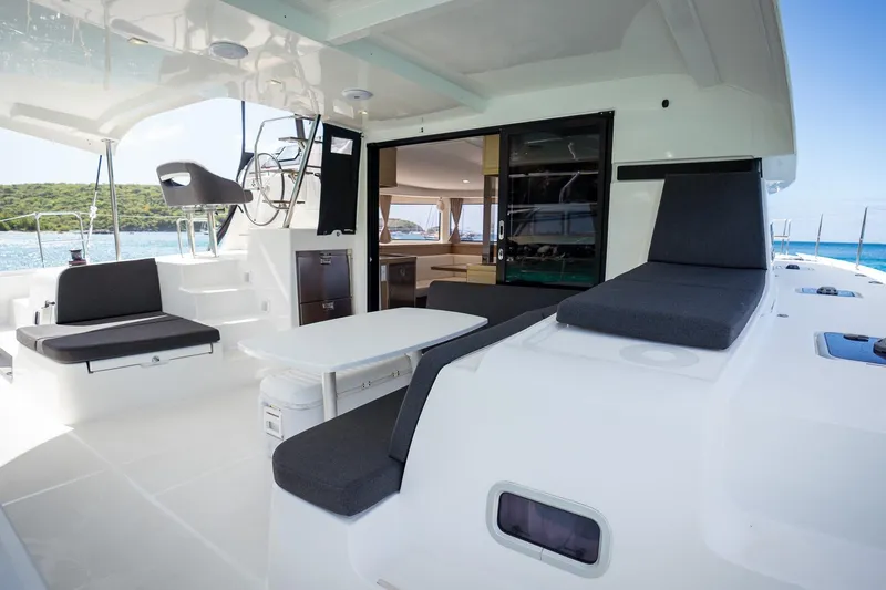 Tide Together Yacht Photos Pics Spacious deck of 2023 Lagoon 42 catamaran with seating and ocean view.