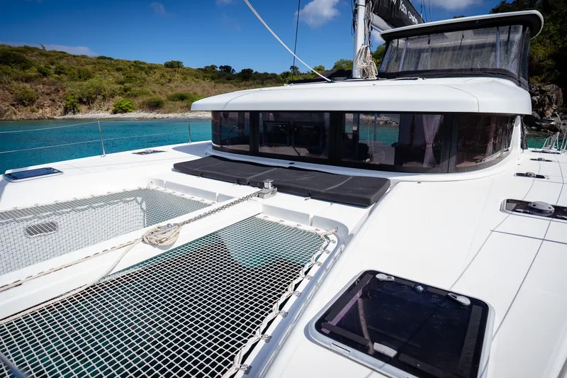 Tide Together Yacht Photos Pics 2023 Lagoon 42 catamaran on turquoise water, featuring spacious deck and modern design.
