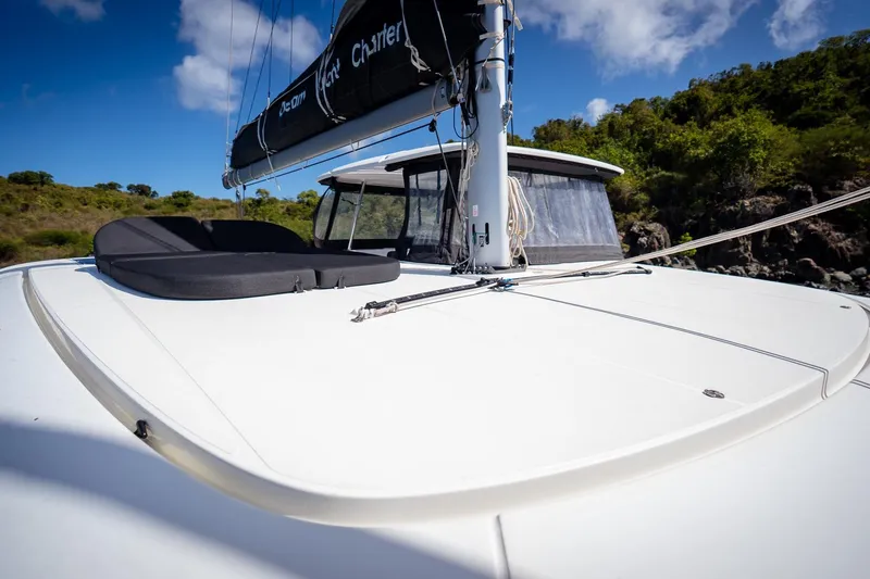 Tide Together Yacht Photos Pics 2023 Lagoon 42 catamaran deck with sunbed, under clear blue sky.