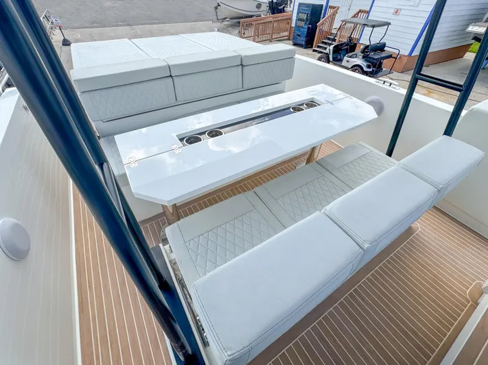  Yacht Photos Pics 2024 De Antonio Yachts D28 Open interior with sleek seating and modern table design.