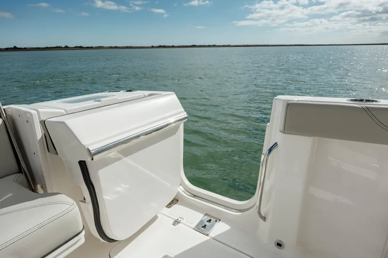 Mindy's Tyde III Yacht Photos Pics 2022 Pursuit S 328 boat with open side door on calm water.