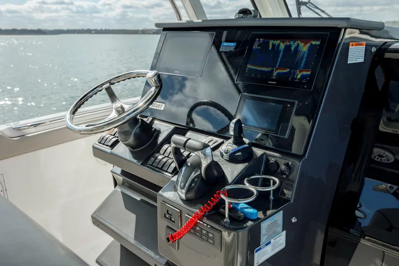 Mindy's Tyde III Yacht Photos Pics 2022 Pursuit S 328 boat helm with advanced navigation and control systems.