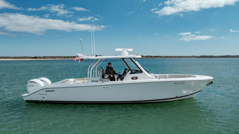 Mindy's Tyde III Yacht Photos Pics 2022 Pursuit S 328 boat cruising on clear blue water under a sunny sky.