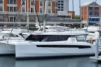 2022 Leopard 50 catamaran docked in a marina, surrounded by other boats.