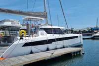 2022 Leopard 50 catamaran docked at marina under clear blue sky.