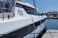 2022 Leopard 50 yacht docked at marina under clear blue sky.