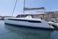 2022 Leopard 50 catamaran docked at marina under clear blue sky.
