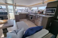 Luxurious interior of a 2022 Leopard 50 yacht with modern kitchen and seating area.