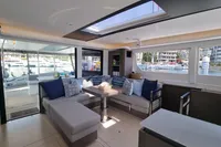 Luxurious interior of 2022 Leopard 50 yacht with modern seating and large windows.