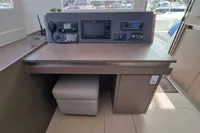 Navigation station on 2022 Leopard 50 yacht with modern equipment and seating.