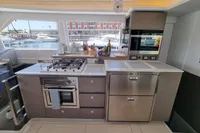 Modern kitchen in a 2022 Leopard 50 yacht with stainless steel appliances and marina view.