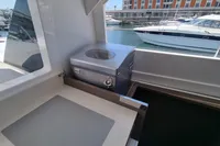 Outdoor kitchen area on a 2022 Leopard 50 yacht, featuring a built-in grill and marina view.