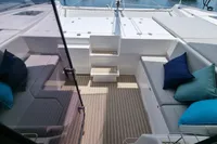 Luxurious Leopard 50 yacht deck with cushioned seating and vibrant pillows, 2022 model.
