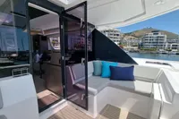 Luxurious Leopard 50 yacht interior with modern seating, vibrant cushions, and marina view.