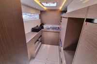Modern interior of 2022 Leopard 50 yacht with wood finish and ample storage.