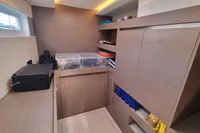 Modern interior of 2022 Leopard 50 yacht with storage and sleek wooden cabinetry.