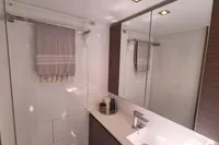 Modern bathroom interior in 2022 Leopard 50 yacht, featuring sleek design and mirrored cabinets.