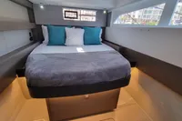 Luxurious cabin interior of 2022 Leopard 50 yacht with cozy bed and modern design.