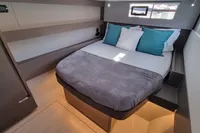 Luxurious cabin interior of 2022 Leopard 50 yacht with cozy bed and modern decor.