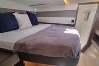 Luxurious cabin interior of 2022 Leopard 50 yacht with cozy bedding and modern design.