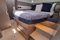 Luxurious cabin interior of 2022 Leopard 50 yacht with bed and storage drawers.