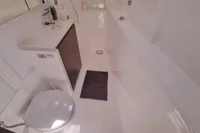 Modern bathroom in 2022 Leopard 50 yacht, featuring sleek design and compact amenities.