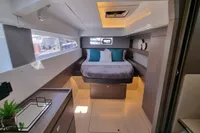 Luxurious cabin interior of a 2022 Leopard 50 yacht with modern design and cozy bedding.
