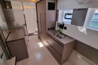 Modern interior of 2022 Leopard 50 yacht with sleek cabinetry and natural light.