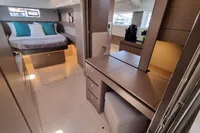 Luxurious interior of 2022 Leopard 50 yacht featuring a cozy bedroom and modern furnishings.