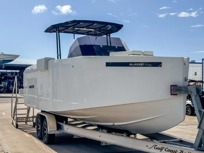  Yacht Photos Pics 2024 De Antonio Yachts D28 Open on trailer, sleek design, sunny day.