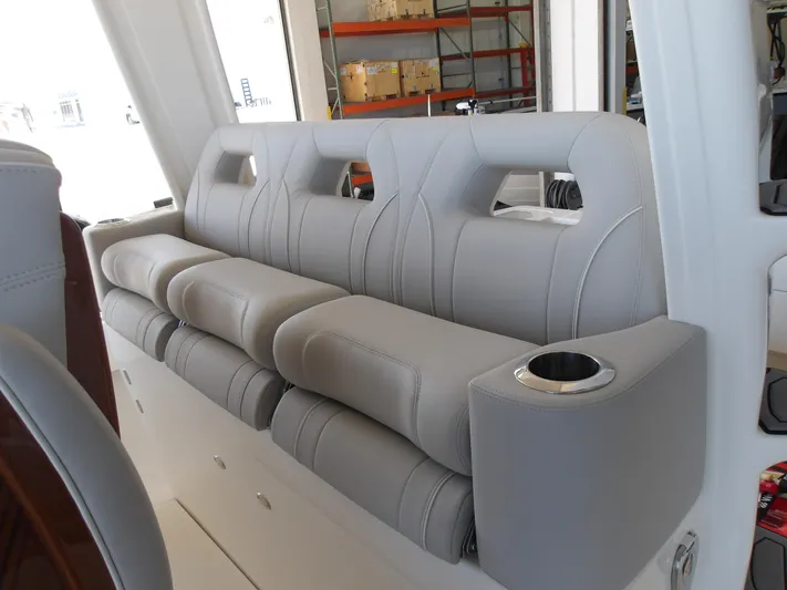  Yacht Photos Pics 2025 SeaVee 420Z boat interior with gray cushioned seating and cup holder.