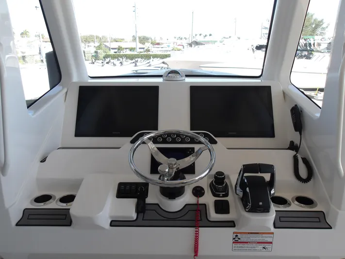  Yacht Photos Pics Helm of 2025 SeaVee 420Z boat with dual screens and modern controls.