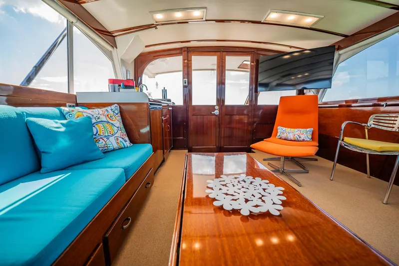 Miss Phebe II Yacht Photos Pics Luxurious interior of a 1971 Whiticar 62 Convertible yacht with vibrant seating and elegant decor.