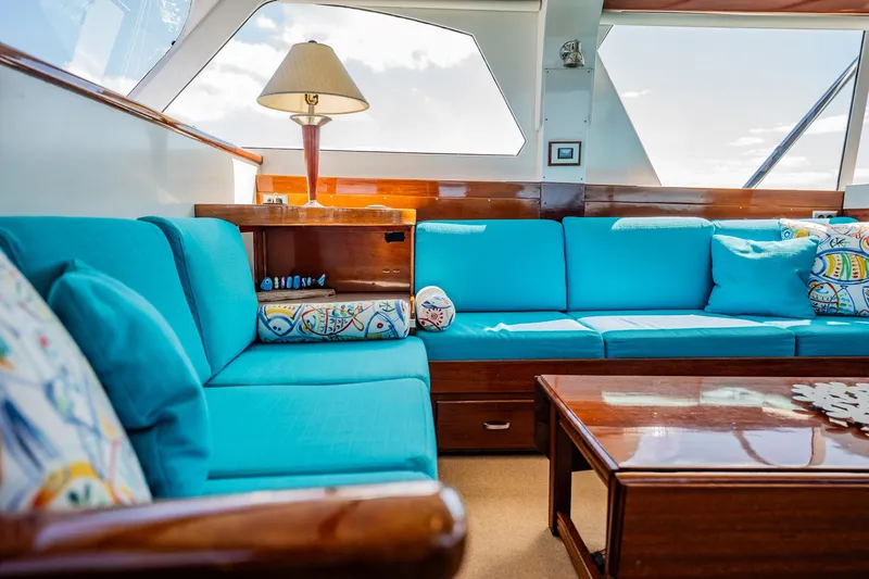Miss Phebe II Yacht Photos Pics Luxurious interior of a 1971 Whiticar 62 Convertible yacht with vibrant blue seating.